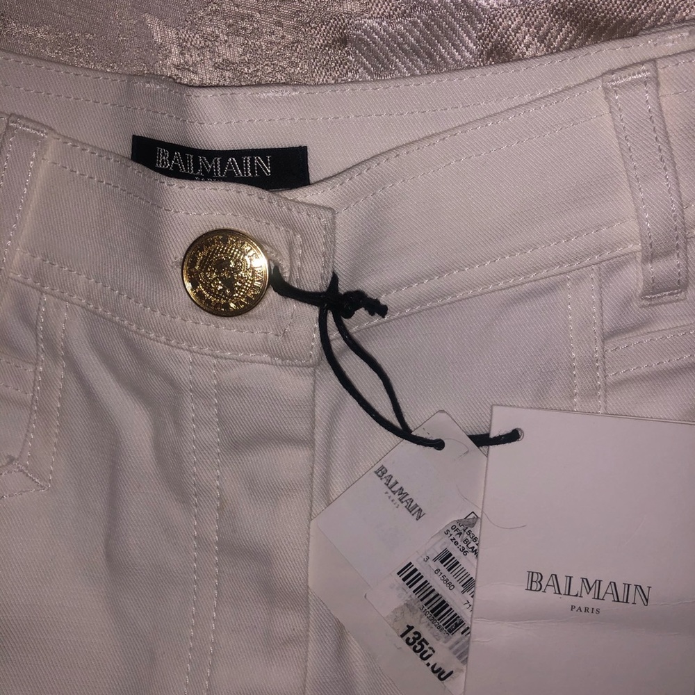 with gold buttons and zipper on the sides,
